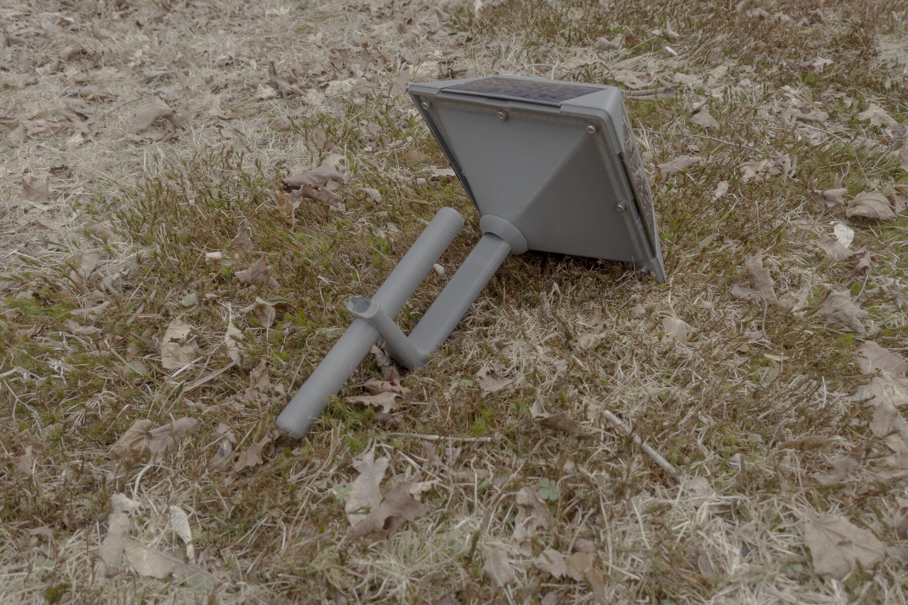 Rear underside view showing the relay base and lower mounting stake hardware.