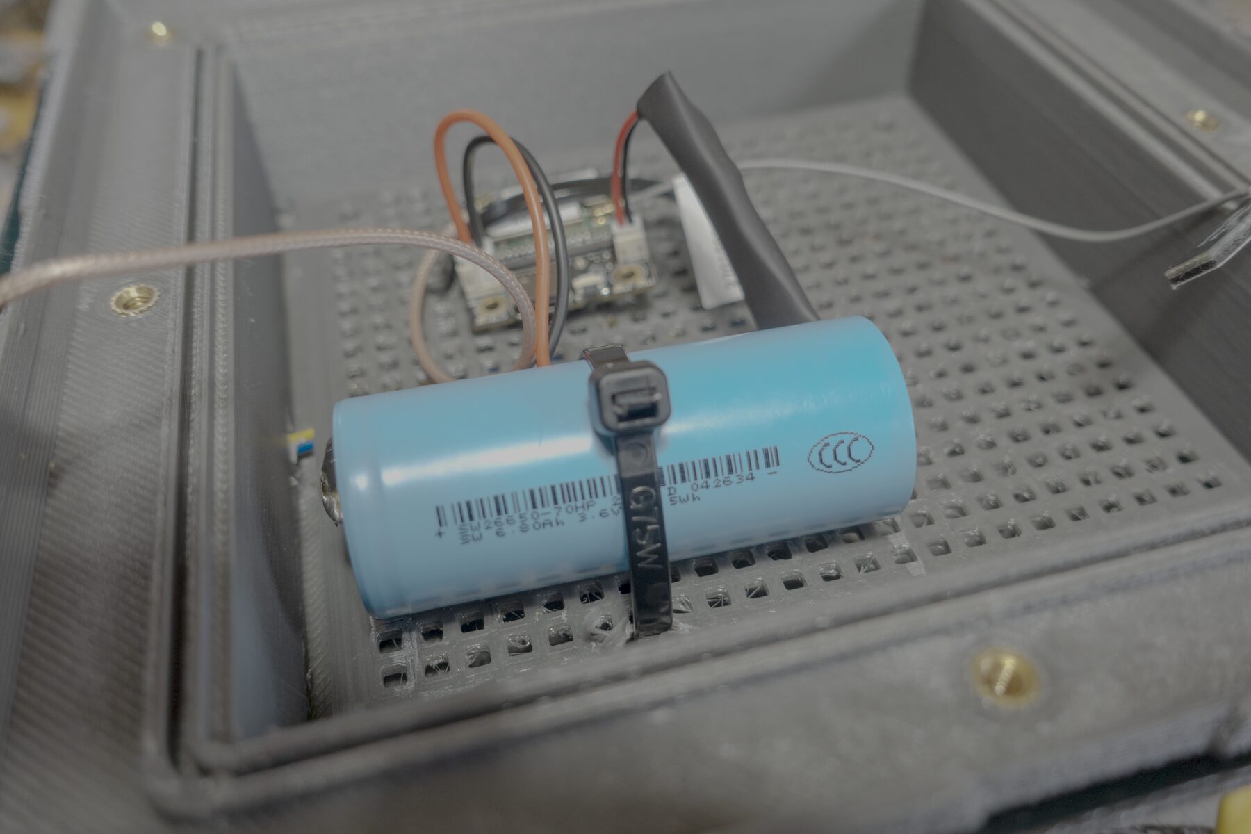 Open lantern node enclosure showing the serviceable single-cell battery compartment.